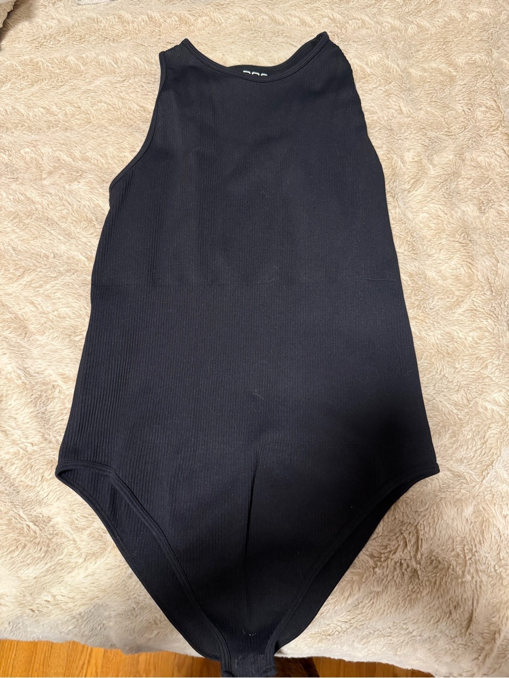Women’s Black Ribbed One-Piece Bodysuit. OQQ